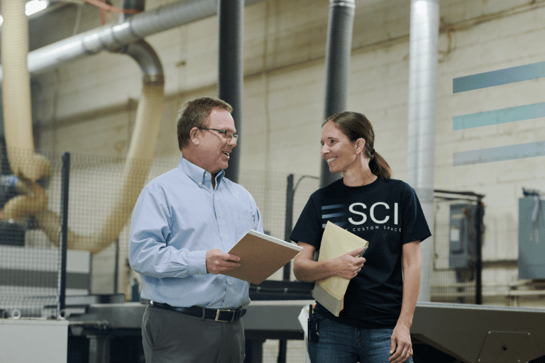 SCI team members speaking in the warehouse.