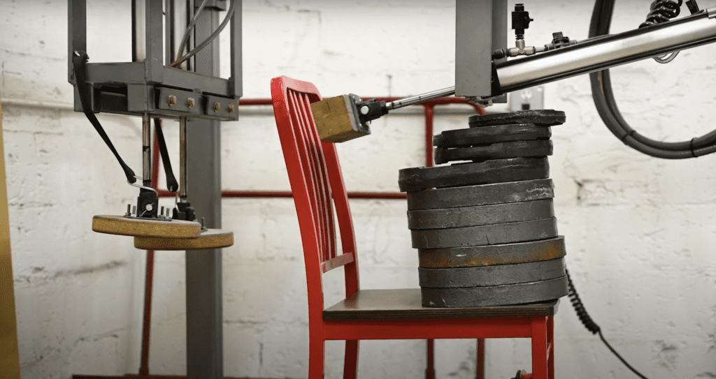 Red chair going through quality testing.