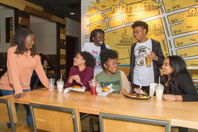 The Den University cafeteria with students.