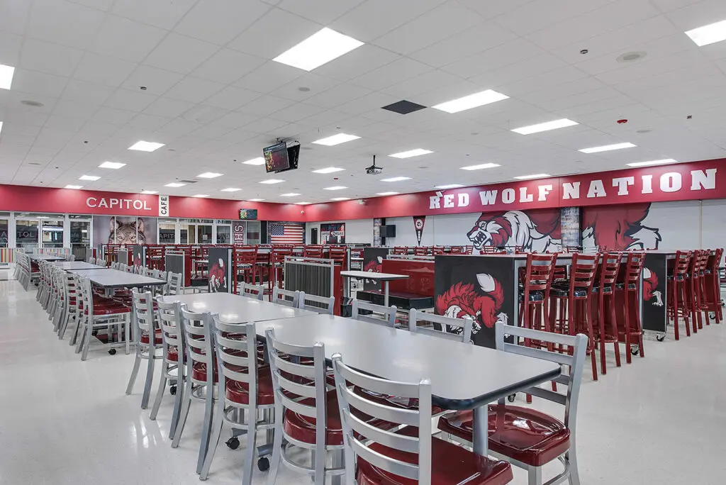 Capitol Hill High School cafeteria with updated furniture and graphics featuring the mascot.