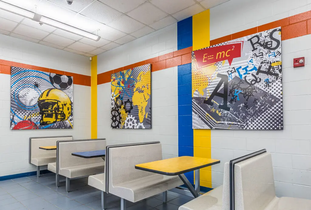 Middle school cafeteria with graphics in school colors, blue and yellow.