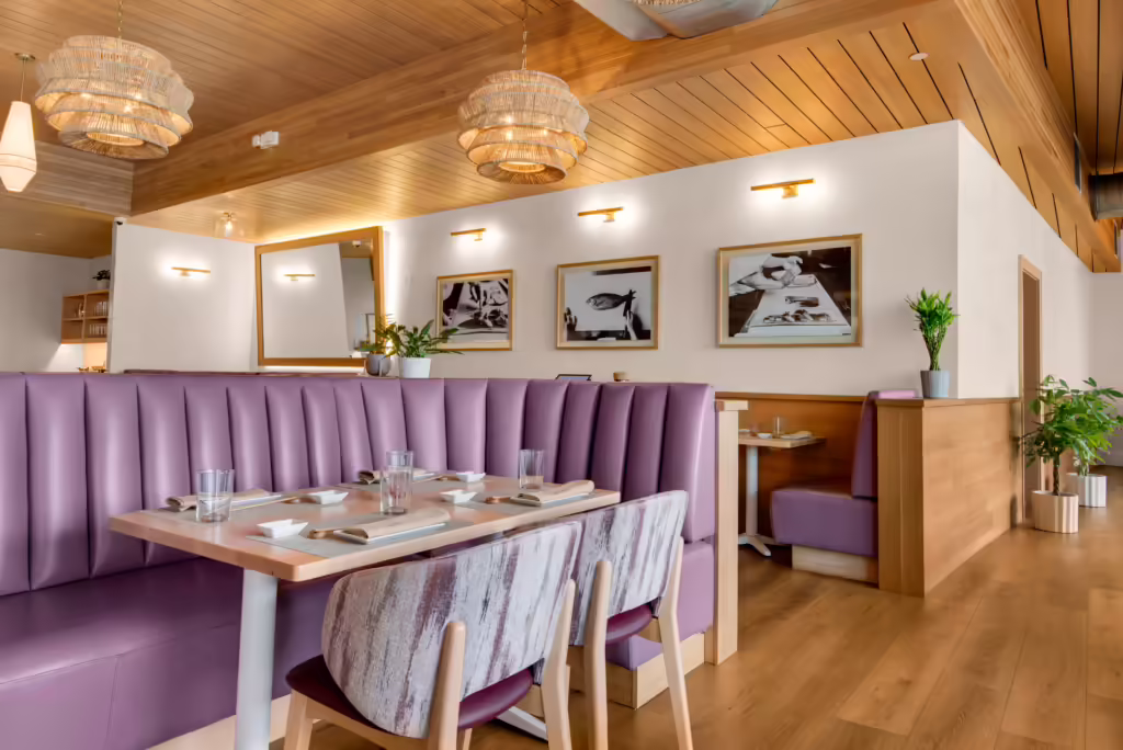 Oku Sushi booths and chairs with bright wood color and purple upholstery.