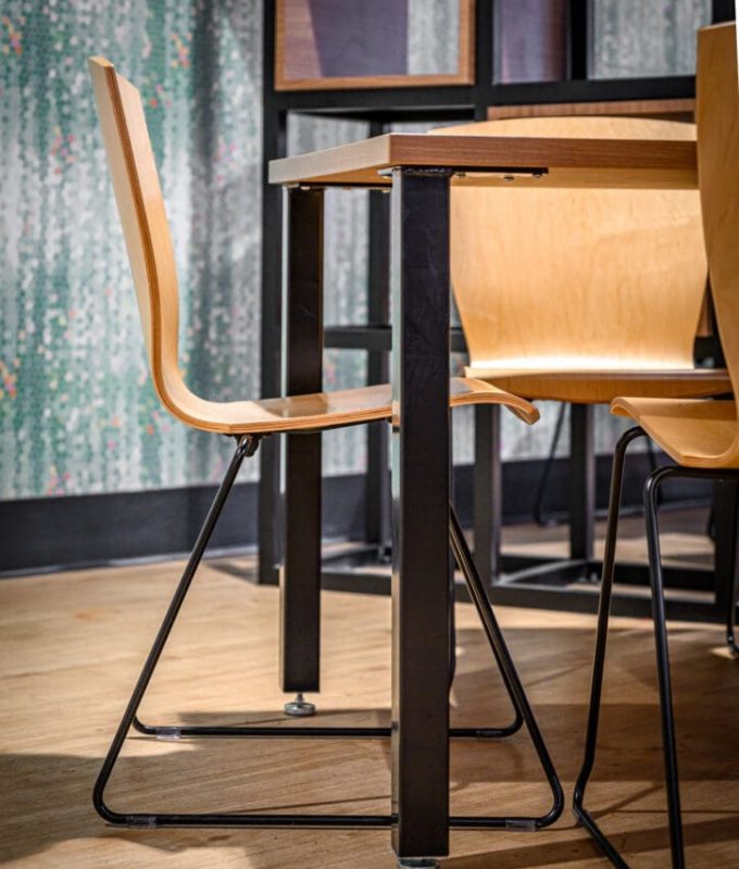 Queens University cafeteria wood seat with metal frame.